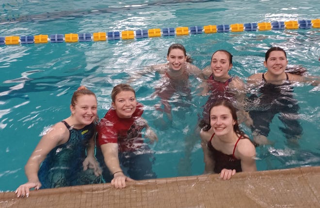 Shelby coach Baylie White and her girls take the plunge after dethroning Ontario in the MOAC swim meet