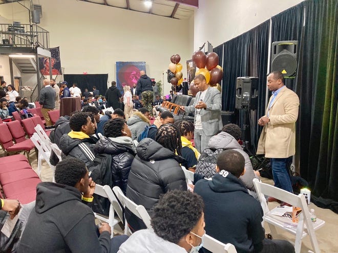 Corie Priest, a Community Engagement Specialist at the Delaware Department of Justice and Justin Womack, owner of restaurant Oath 84 speak to young men during a breakout session at the 9th annual Raising Kings Conference in Wilmington.