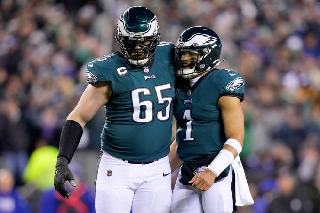 Philadelphia Eagles offensive tackle Lane Johnson (left) and quarterback Jalen Hurts (right) celebrate after a touchdown against the New York Giants during the first quarter in their divisional round game.