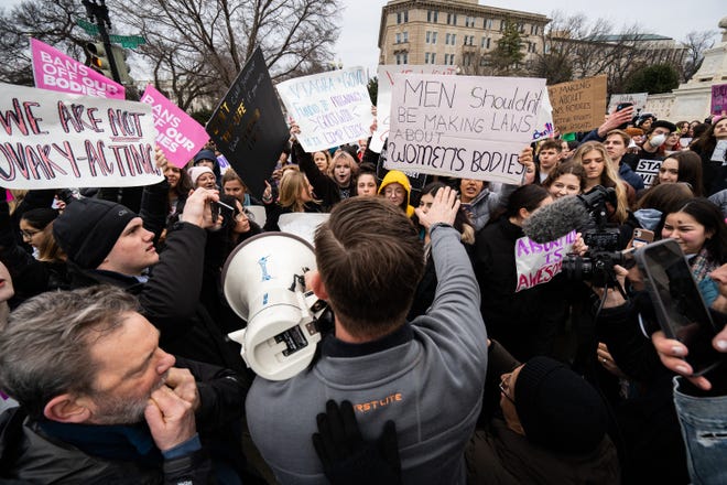 Abortion-rights and anti-abortion activists clash outside of the Supreme Court building after participants of the Women's March walked there from the White House on January 22, 2023.