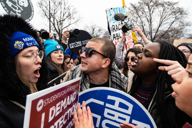 Abortion-rights and anti-abortion activists clash outside of the Supreme Court building after participants of the Women's March walked there from the White House on January 22, 2023.