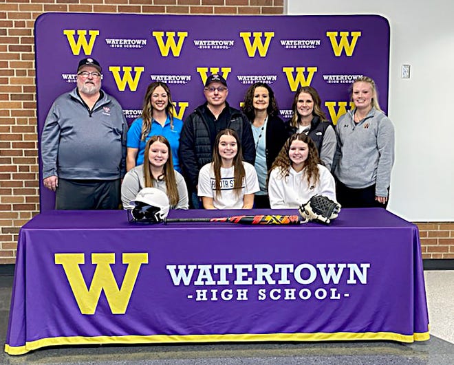 Watertown High School senior Jada Brown (front center) signed a letter of commitment last Thursday to play women's college softball at Dakota State University in Madison. Also pictured are her sisters Jenna (left) and Alexa (right) in front; and back (from left), USA Softball of South Dakota commissioner Gary Young, DSU assistant coach Alexandria Holland, her dad David and mom Gina, Watertown High School head varsity softball coach Kelli Brinka and WHS junior varsity coach Katie Strande. Jada Brown has pitched for the Watertown Arrows fall fastpitch team since her eighth-grade year and pitched and played first base on the Arrows' state championship team last fall. She has played travel ball with Midwest United 18-and-Under and the South Dakota Thunder the past two years.