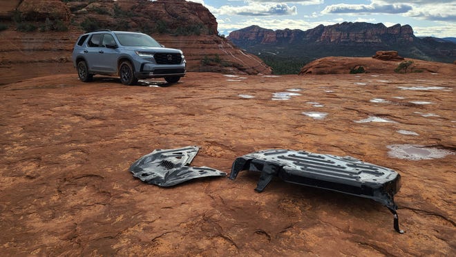 Got skid plates? A display of the twin skid plates standard on a 2023 Honda Pilot TrailSport to protect the underbelly from off-road harm.