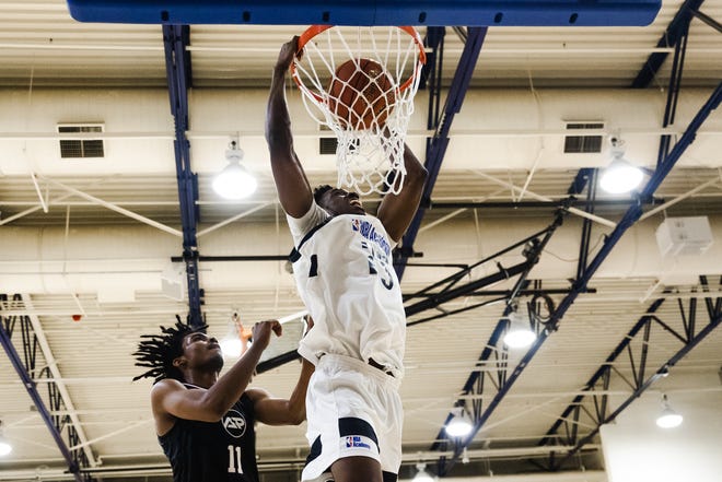 Louisville men's basketball player Emmanuel Okorafor, middle, dunks the ball while playing in a game for NBA Academy Africa. Okorafor, who joined the Cardinals on Jan. 19, 2023, spent time competing as an amateur in the Basketball Africa League.