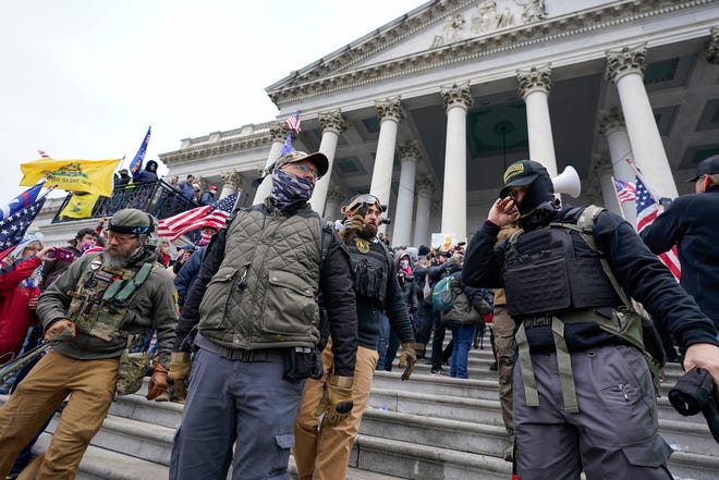 Members of the Oath Keepers extremist group stand on the East Front of the U.S. Capitol on Jan. 6, 2021, in Washington. The Capitol riot was the culmination of weeks of preparation and a moment of triumph for the Oath Keepers, federal prosecutor Louis Manzo said Jan. 18, 2023, in closing arguments in the second seditious conspiracy trial against members of the far-right extremist group. The defendants facing jurors in the latest trial are Joseph Hackett, Roberto Minuta, David Moerschel, and Edward Vallejo.