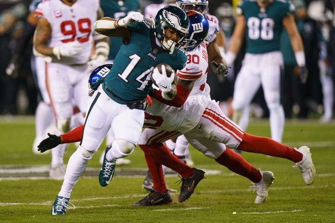 Philadelphia Eagles running back Kenneth Gainwell (14) runs with the ball past New York Giants safety Julian Love (20) and corner back Darnay Holmes (30) during the NFL divisional round playoff football game, Saturday, Jan. 21, 2023, in Philadelphia.