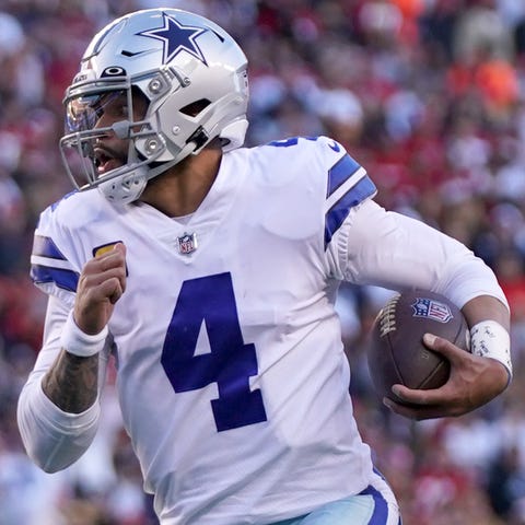 Cowboys QB Dak Prescott scrambles as the 49ers' Ni