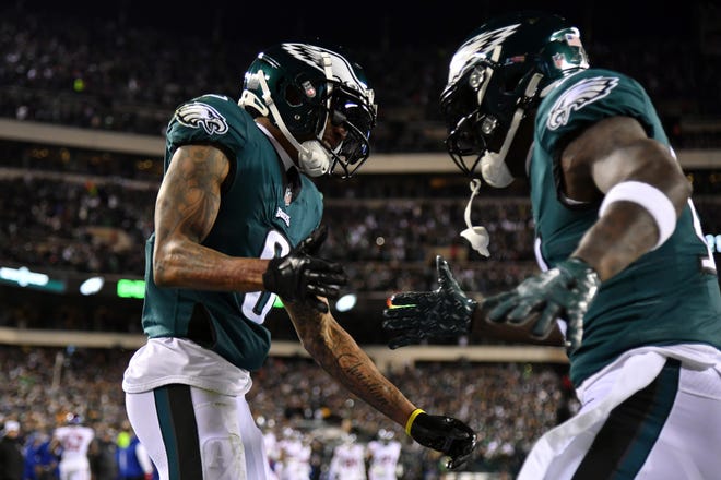 Philadelphia Eagles wide receiver DeVonta Smith (6) celebrates with wide receiver A.J. Brown (11) after scoring a touchdown in the first quarter against the New York Giants in an NFC divisional round game at Lincoln Financial Field.