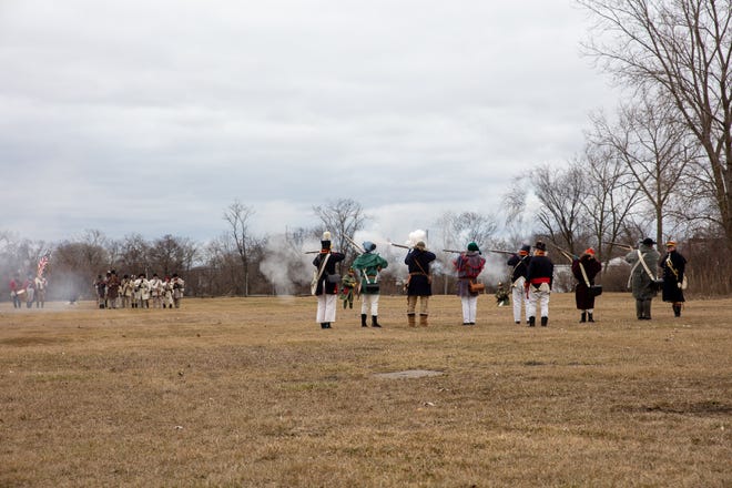 Participants in a battle reenactment from the River Raisin battles during the War of 1812 fire muskets with blank ammunition Saturday, Jan. 21, 2023, at the River Raisin National Battlefield Park in Monroe.