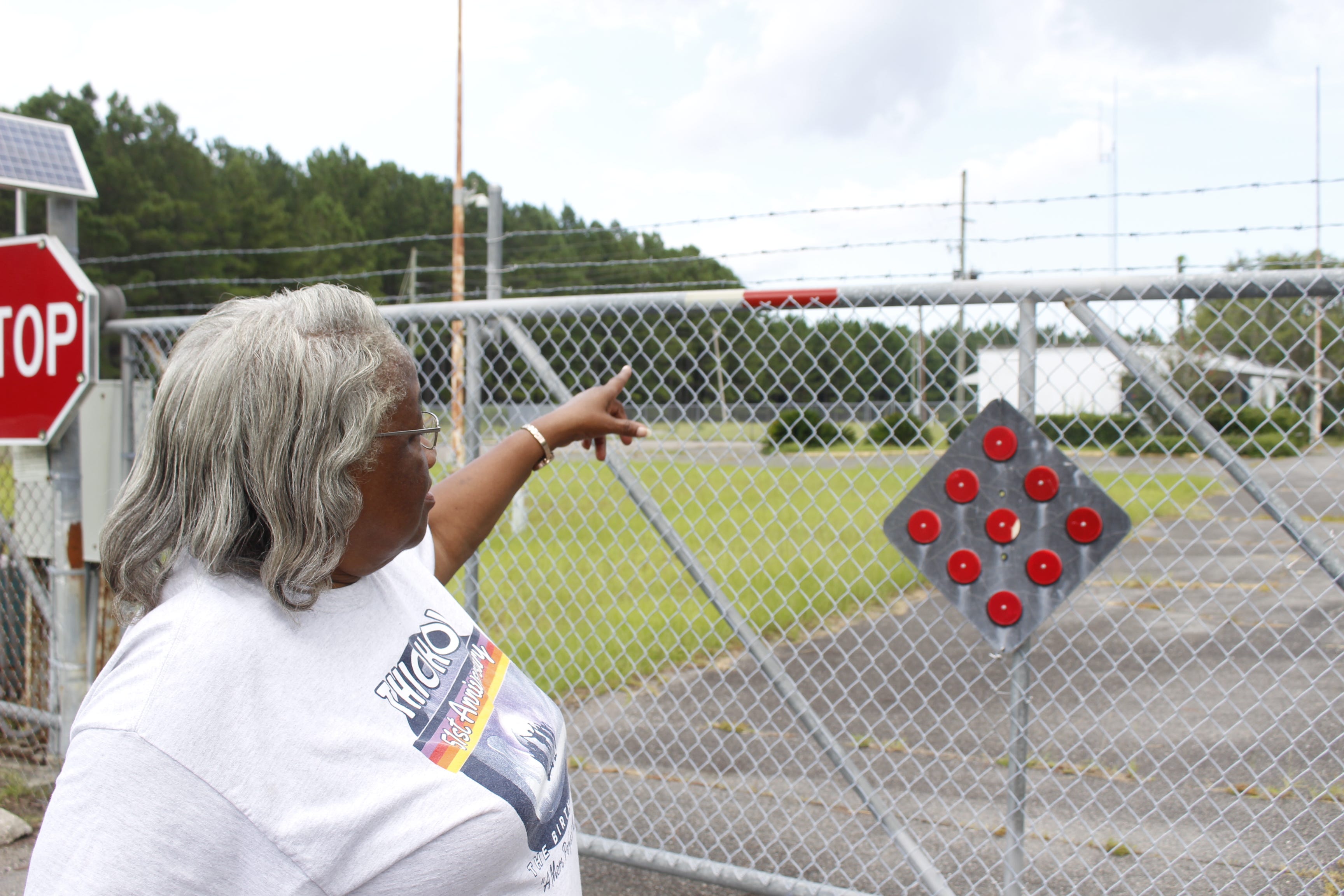 For the first time in 16 years, Emma Lue Gibbs stands outside the Thiokol Chemical Corporation plant in Woodbine, Georgia, where she worked for decades and was present the day an explosion killed 30 of her fellow workers and injured several others in 1971.