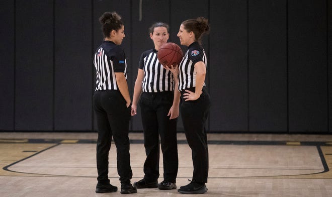 Referees McKenna Beach, left, Karlea Kyllo and Rachel Ladygo, right, gather after the third quarter of the Bishop Verot - SFCA basketball game on Monday, Jan 23, 2023, in Fort Myers.