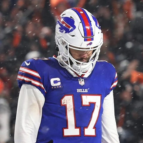 Josh Allen walks off the field after throwing an i