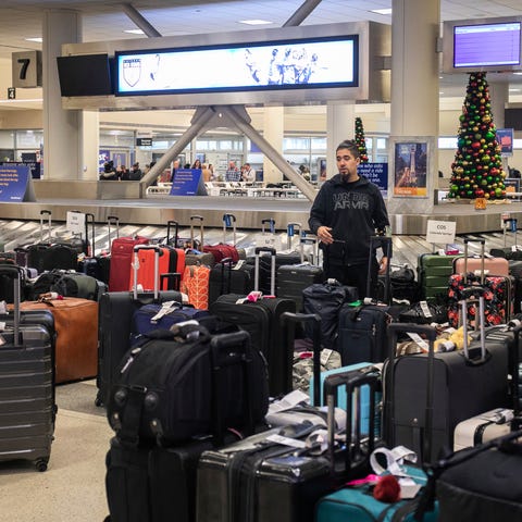 A person looks for lost luggage near the baggage c