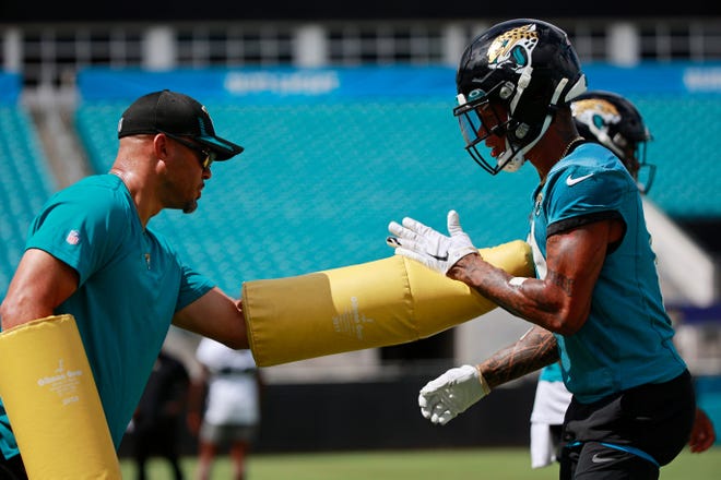 Jacksonville wide receivers coach Chris Jackson works with receiver Marvin Jones Jr. last summer. Jackson, who has been hired by Texas, helped Christian Kirk and Zay Jones record two of the franchise's top 10 seasons for receptions.