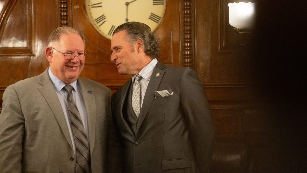Senate President Ty Masterson, R-Andover, right, exchanges words with House Speaker Dan Hawkins, R-Wichita, left, before the start of Tuesday's State of the State address.