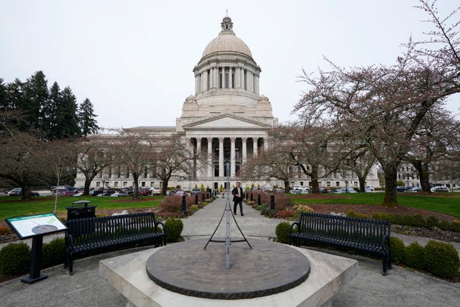 The sun dial near the Legislative Building is shown under cloudy skies, March 10, 2022, at the state Capitol in Olympia, Wash. An effort to balance what is considered the nation's most regressive state tax code comes before the Washington Supreme Court on Thursday, Jan. 26, 2023, in a case that could overturn a prohibition on income taxes that dates to the 1930s.