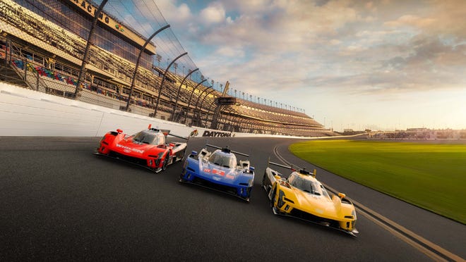 Cadillac V-LMDhm GTP race cars wear blue, red and gold liveries at Daytona International Speedway for the Rolex 24 Hours of Daytona.