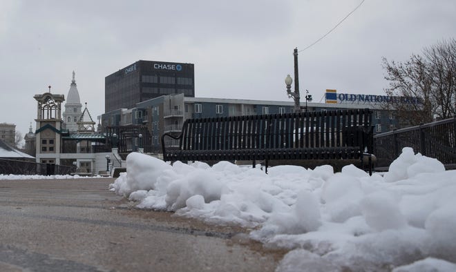 Snow accumulates on the pedestrian bridge that crosses the Wabash River, Thursday, Jan. 26, 2023, in Lafayette, Ind. 