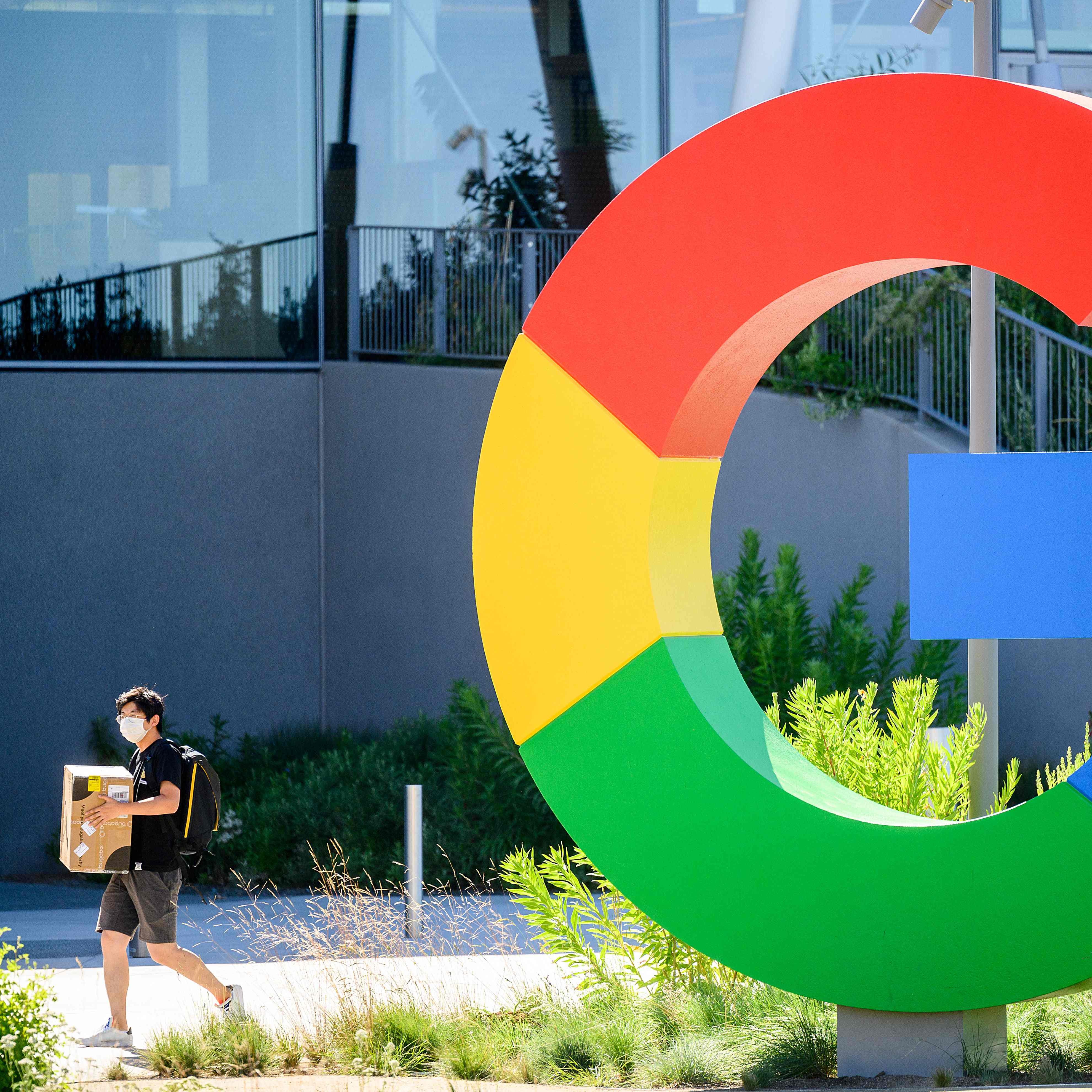 (FILES) In this file photo taken on June 27, 2022, a worker walks along a path at Googles Bay View campus in Mountain View, California. - Google's parent company Alphabet announced about 12,000 job cuts globally on January 20, 2023, citing a changing "economic reality", becoming the latest US tech giant to enact large-scale restructuring. The layoffs come a day after Microsoft said it would reduce staff numbers by 10,000 in the coming months, following similar cuts by Facebook owner Meta, Amazon and Twitter as   the previously unassailable tech sector battles a major economic downturn. (Photo by NOAH BERGER / AFP) (Photo by NOAH BERGER/AFP via Getty Images) ORIG FILE ID: AFP_337G9LU.jpg