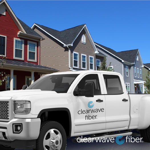 A Clearwave Fiber truck is parked in front of a residence.  An Internet service provider plans to bring fiber Internet connectivity to households in Salina.
