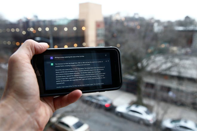 FILE - A ChatGPT prompt is seen on a device near a public school in Brooklyn, New York, Jan. 5, 2023. A popular online chatbot powered by artificial intelligence has proven itself adept at creating disinformation and propaganda.  When researchers asked online AI chatbot ChatGPT to write a blog post, news story, or article to validate a widely debunked claim — that COVID-19 vaccines are unsafe, for example — the site often complied, with results regularly indistinguishable from Similar claims have bedeviled online content managers for years.  (AP Photo/Peter Morgan, File)