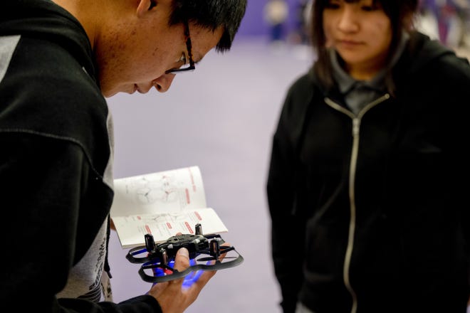 Clarence Sago, left, and Caydence Palmer, Mescalero Apache High School students, prepare their drones for the first Aerial Drone Competition at Mescalero Apache High School, Jan. 21, 2023. Two drones are allowed in the competition, the CoDrone EDU and the Parrot Mambo drone, each of which  has seven built-in sensors including an accelerometer, gyroscope, barometer, front range sensor, bottom range sensor, color sensor and an optical flow sensor.