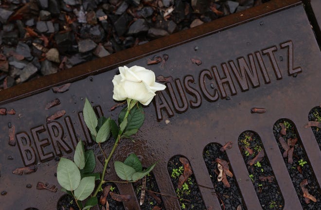 A flower left by a participant lies at the railway tracks at the Gleis 17 memorial during a small commemoration gathering on Holocaust Remembrance Day on Jan. 27, 2023, in Berlin, Germany. The Gleis 17 memorial is located at the train platform from which the Nazis deported thousands of Berlin Jews by rail to the Auschwitz and Theresienstadt concentration camps during World War II. Holocaust Remembrance Day, which falls on the anniversary of the Jan. 27, 1945 liberation of the Auschwitz concentration camp, commemorates the millions of people murdered and persecuted by the Nazis from the 1930s and into World War II. The victims include over five million Jews, as well as political opponents, Roma, other religious groups, and homosexuals.