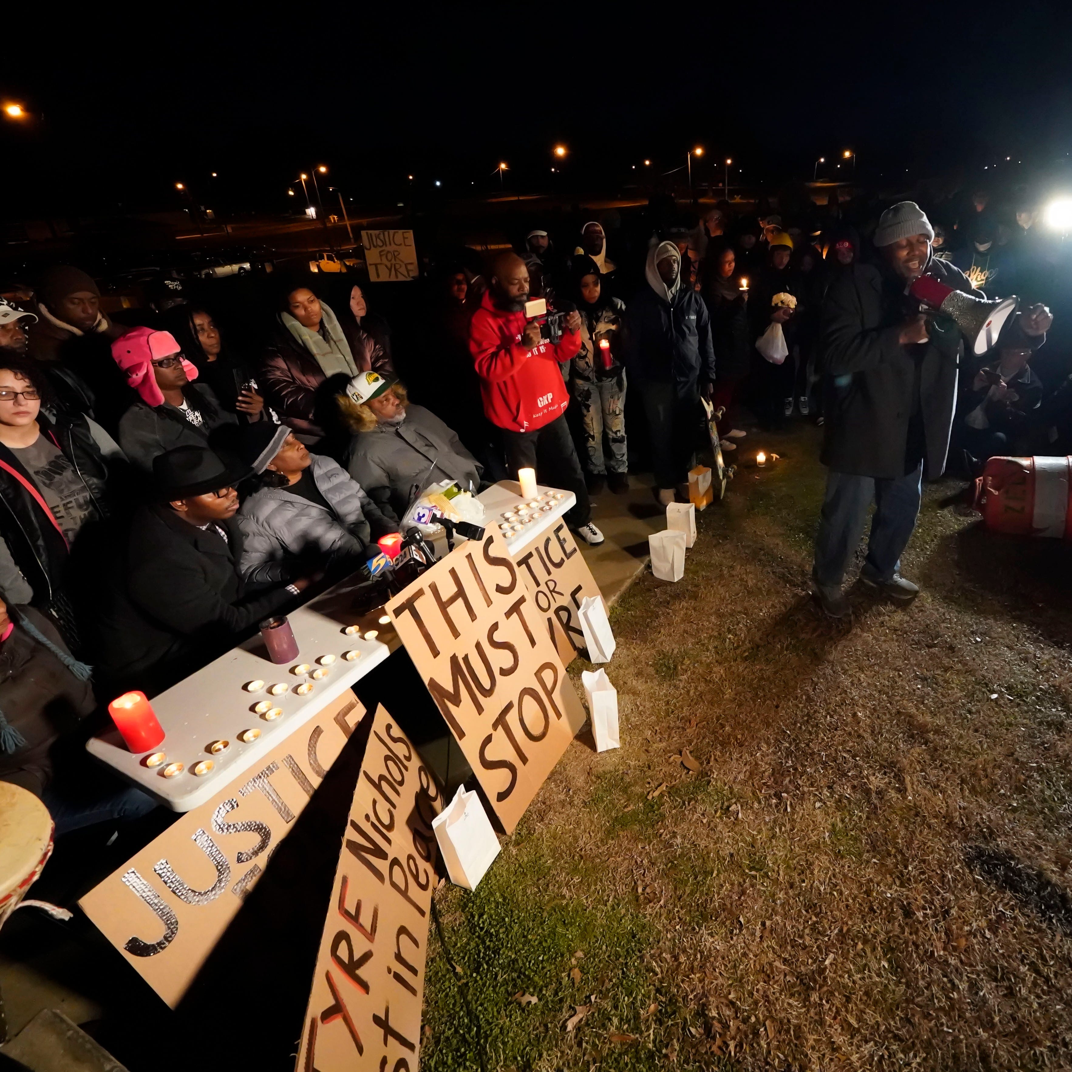 Rev. Andre E Johnson, of the Gifts of Life Ministries, preaches at a candlelight vigil for Tyre Nichols, who died after being beaten by Memphis police officers, in Memphis, Tenn., Thursday, Jan. 26, 2023. Behind him, seated center, are Tyre's mother RowVaughn Wells and his stepfather Rodney Wells. (AP Photo/Gerald Herbert)