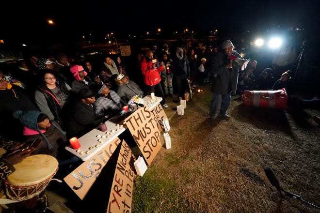 Rev. Andre E Johnson, of the Gifts of Life Ministries, preaches at a candlelight vigil for Tyre Nichols, who died after being beaten by Memphis police officers, in Memphis, Tenn.. Behind him, seated center, are Tyre's mother RowVaughn Wells and his stepfather Rodney Wells.