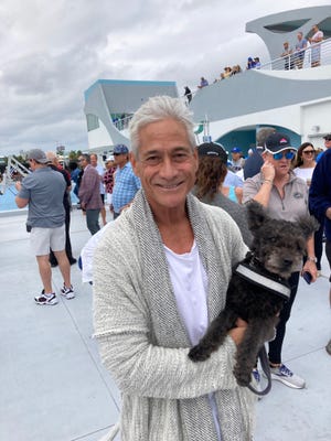 Greg Louganis and his dog, a Hungarian Pumi named Gene, attended Saturday's festivities at the International Swimming Hall of Fame.