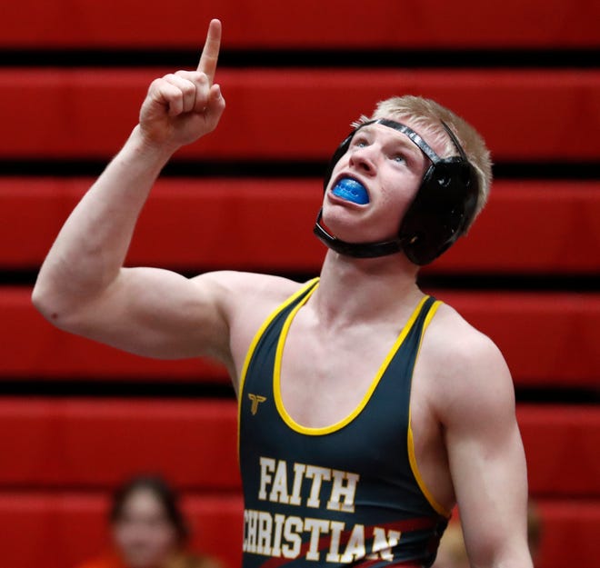 Faith Christian’s Eli Blossom celebrates after the 145 lbs championship during the IHSAA wrestling sectional championship, Saturday, Jan. 28, 2023, at Lafayette Jeff High School in Lafayette, Ind.