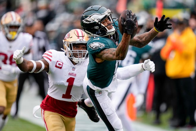 Philadelphia Eagles wide receiver DeVonta Smith, right, catches a pass in front of San Francisco 49ers cornerback Jimmie Ward during the first half of the NFC Championship NFL football game between the Philadelphia Eagles and the San Francisco 49ers on Sunday, Jan. 29, 2023, in Philadelphia.