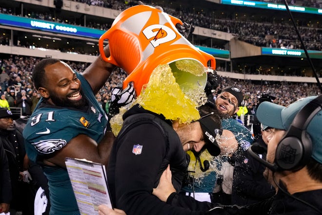 Philadelphia Eagles head coach Nick Sirianni, center, is doused by defensive tackle Fletcher Cox (91) and teammates during the second half of the NFC Championship NFL football game between the Philadelphia Eagles and the San Francisco 49ers on Sunday, Jan. 29, 2023, in Philadelphia. (AP Photo/Matt Slocum)