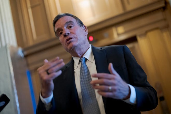 Sen. Mark Warner, D-Va., chair of the Senate Intelligence Committee, pauses to speak with reporters at the Capitol in Washington, Nov. 10, 2022. Members of the Senate intelligence committee say they should have access to classified documents that were discovered in the homes of President Joe Biden, former President Donald Trump and former Vice President Mike Pence.