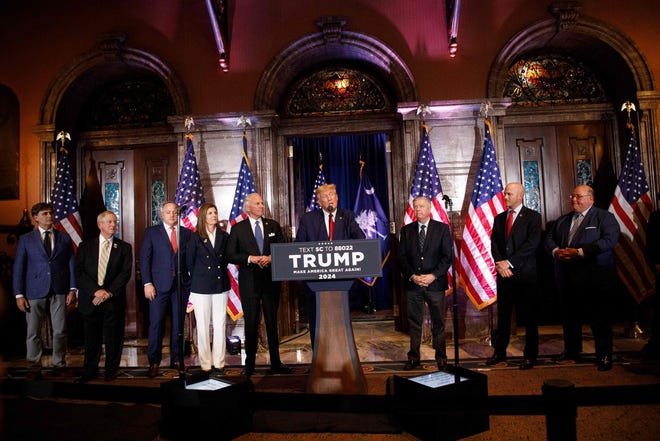 Former US President Donald Trump, joined by members of his leadership team, speaks at a 2024 election campaign event in Columbia, South Carolina, on January 28, 2023.