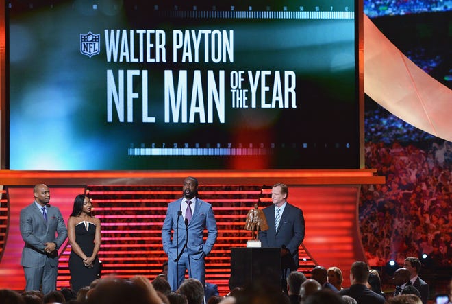 Chicago Bears cornerback Charles Tillman (center) wins the Walter Payton NFL Man of the Year at the third annual NFL Honors at Radio City Music Hall on Feb. 1, 2014, in New York City.