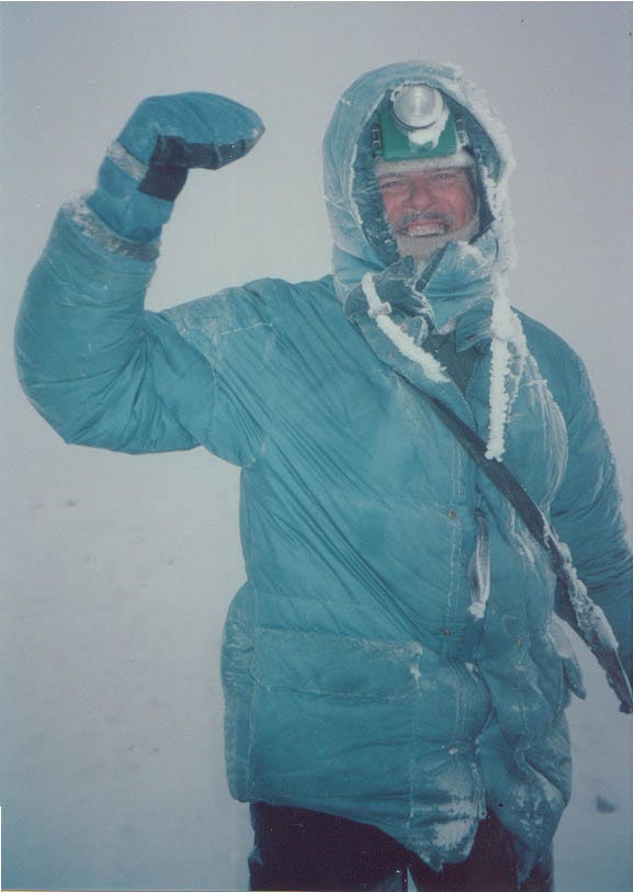 Robert Packard walks through a blizzard on top of Chimborazo, Ecuador's highest peak, 1999. Chimborazo has the distinction of being the mountain whose summit is the furthest from the center of the earth.