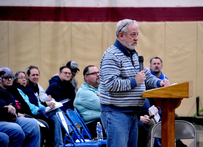 One of many Rittman area residents questions city officials about the city's handling of a mistake that led to a 0.5% overpayment for 15 years by those who pay income tax to Rittman.