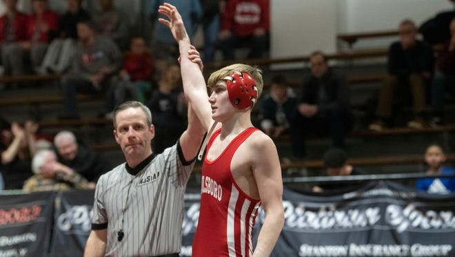 Paulsboro's Chase Bish has his arm raised after Bish defeated Haddonfield's William Bayer by pin during the 132 lb. bout of the wrestling meet held at Haddonfield Memorial High School on Monday, January 30, 2023.  