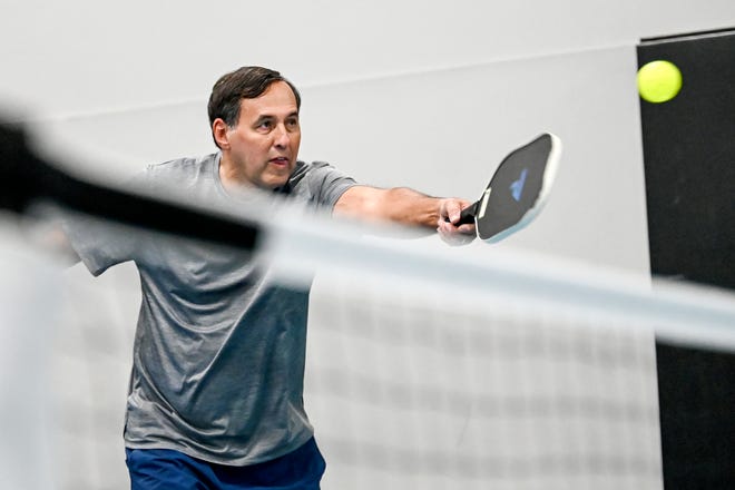 Gary Beaudoin hits the ball during a pickleball match on Friday, Jan. 27, 2023, at Court One Athletic Clubs in Lansing.