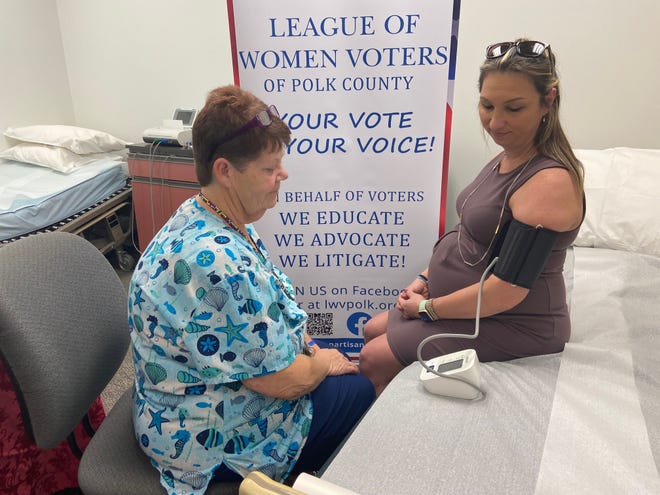 Registered nurse Shelly Benson checked the blood pressure of Emily Crain, president of League of Women Voters of Polk County, during a January event at Florida Department of Health in Lakeland.