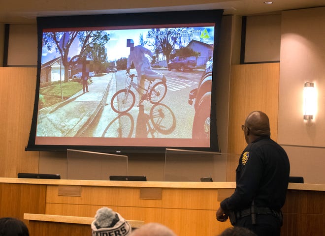 Tracy Police Chief Sekou Millington watches video footage of an officer-involved shooting of a 17-year-old boy during a news conference at Tracy City Hall on Tuesday, Jan. 31, 2023.