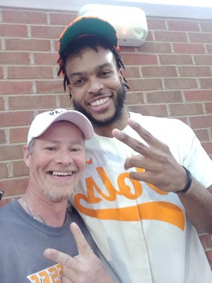 Jeff Vincent with Josiah-Jordan James, one of the Tennessee basketball players who signed the Daddy hat he gave to a 12-year-old boy.