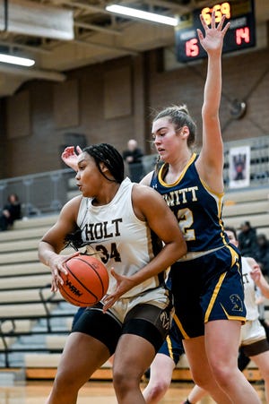 Holt's Janae Tyler, left, moves to the basket as DeWitt's Alex Charles defends during the second quarter on Tuesday, Jan. 31, 2023, at Holt High School.
