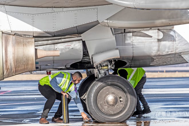 Airport personnel work to ready Avelo Airline's Boeing 737-700 for its first flight to Orlando, Fla., out of New Castle Airport in Wilmington, Wednesday, Feb. 1, 2023. Avelo's inaugural flight marks the return of commercial flight services to Delaware and will offer non-stop trips to five Florida locations.