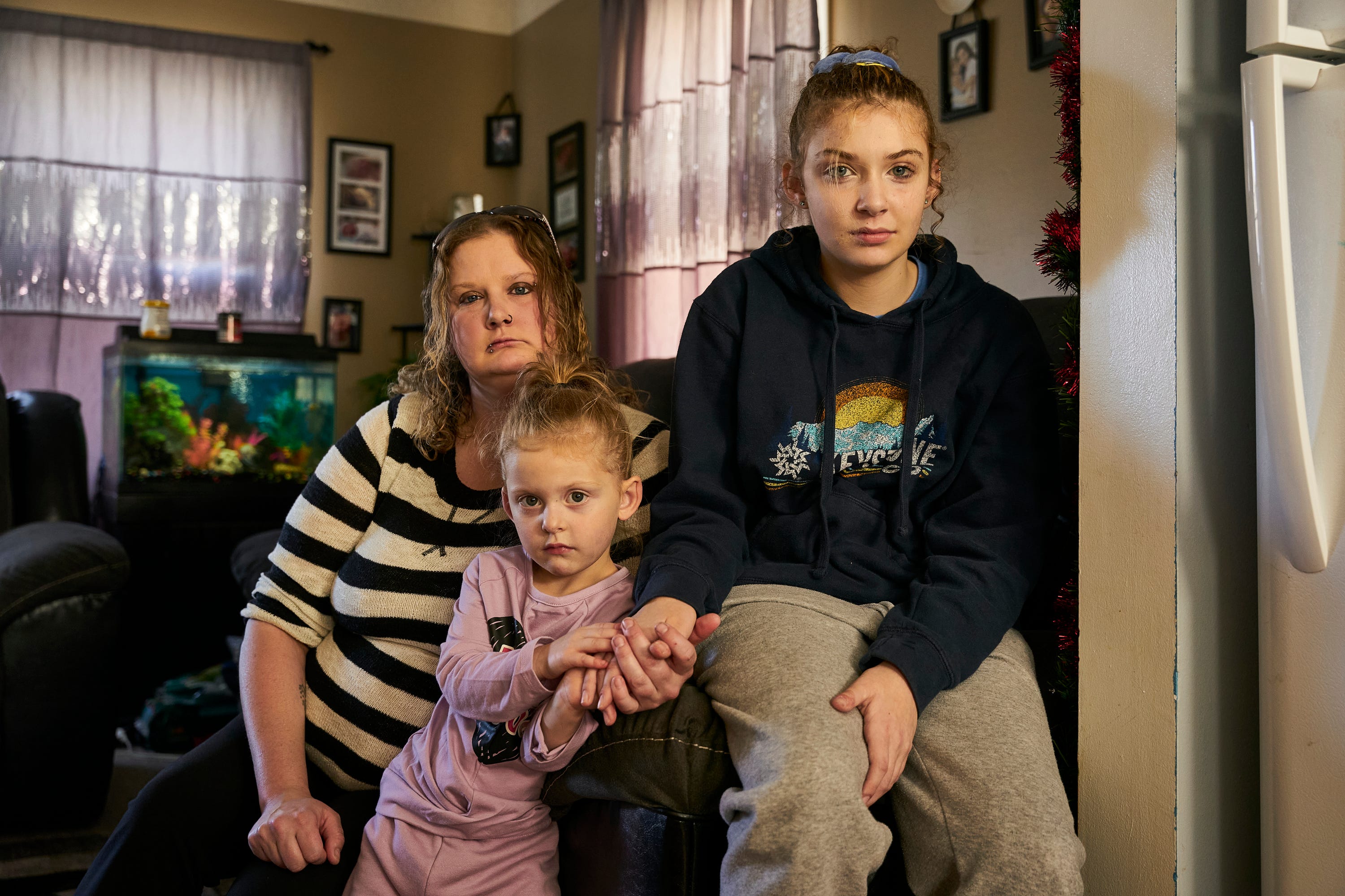 Lauren Marley with her two daughters, 3-year-old Nova and 13-year-old Kaylie, at their home in Quincy, Illinois. In November 2021, Kaylie had to be hospitalized after she was exposed to noxious fumes at Spooner Middle School in Wisconsin.