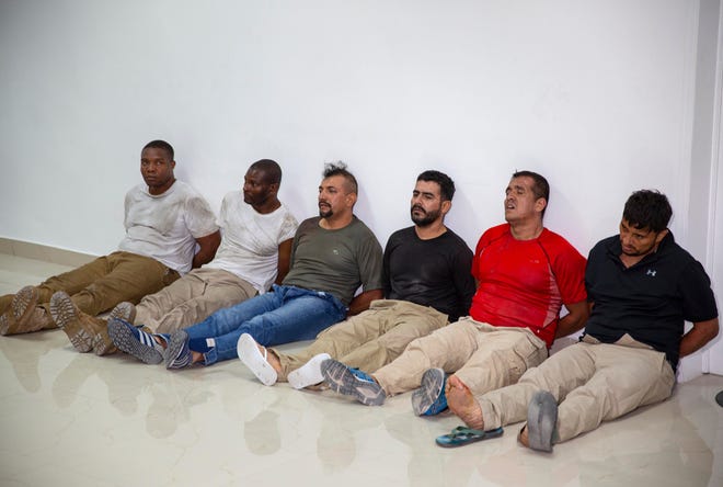 Suspects in the assassination of Haiti's President Jovenel Moise, among them Haitian-American citizens James Solages, left, and Joseph Vincent, second left, are shown to the media at the General Direction of the police in Port-au-Prince, Haiti, Thursday, July 8, 2021. U.S. officials say four key suspects in the killing of Haitian President Jovenel Moïse have been transferred to the United States for prosecution as the case stagnates in Haiti amid death threats that have spooked local judges. The U.S. Justice Department said Tuesday, Jan. 31, 2023, that the suspects include James Solages and Joseph Vincent.