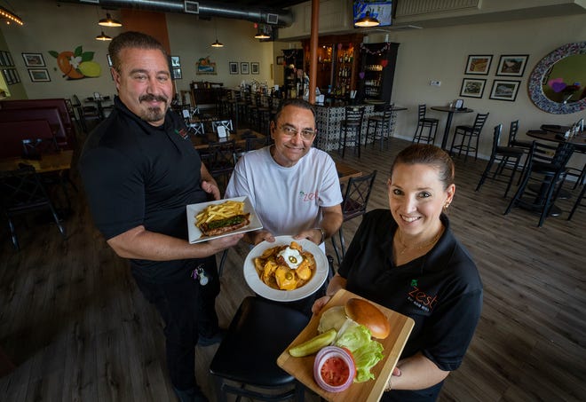 From left, Scott Cammarata, Vincent Posada and Cary Klimczak, struggled through the pandemic to renovate a dilapidated Bartow building and open their restaurant Zest Bar and Grill. The interior is a nod to Bartow's history as the center of the citrus world. The restaurant opened in November, and they're opening a companion fine-dining restaurant soon next door.