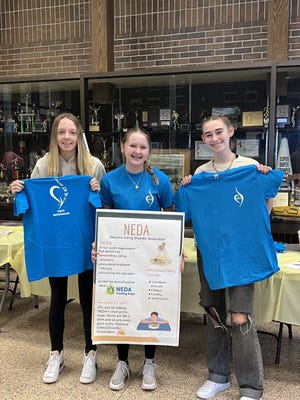 From left, Airport High School DECA members Mariena Lambrix, Raegan Budzios and Cicilia Ortega show the T-shirts DECA created to bring awareness to eating disorders.
(Photo: PROVIDED BY AIRPORT HIGH SCHOOL)