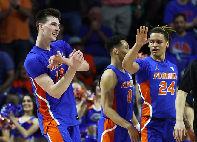 Feb 1, 2023; Gainesville, Florida, USA; Florida Gators forward Colin Castleton (12) celebrates after making a basket against the Tennessee Volunteers during the second half at Exactech Arena at the Stephen C. O'Connell Center. Mandatory Credit: Kim Klement-USA TODAY Sports